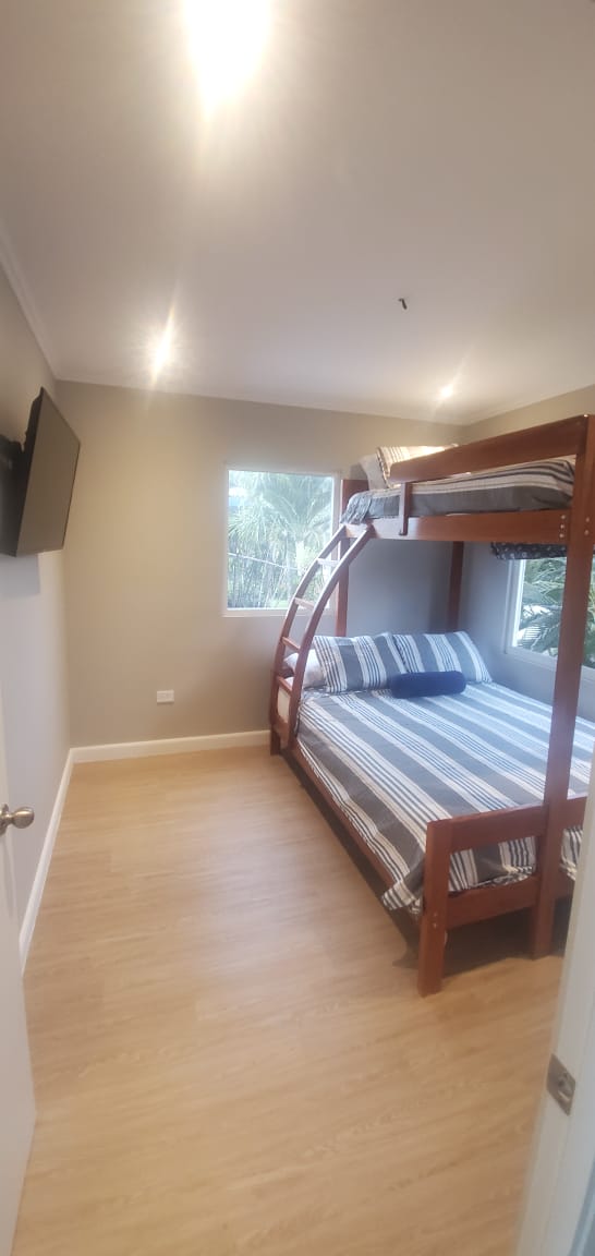 Bedroom with bunk beds and tropical garden view