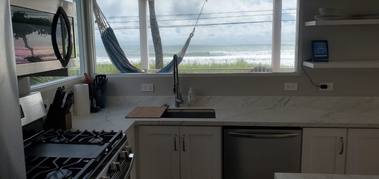 Kitchen with ocean view and hammock visible outside