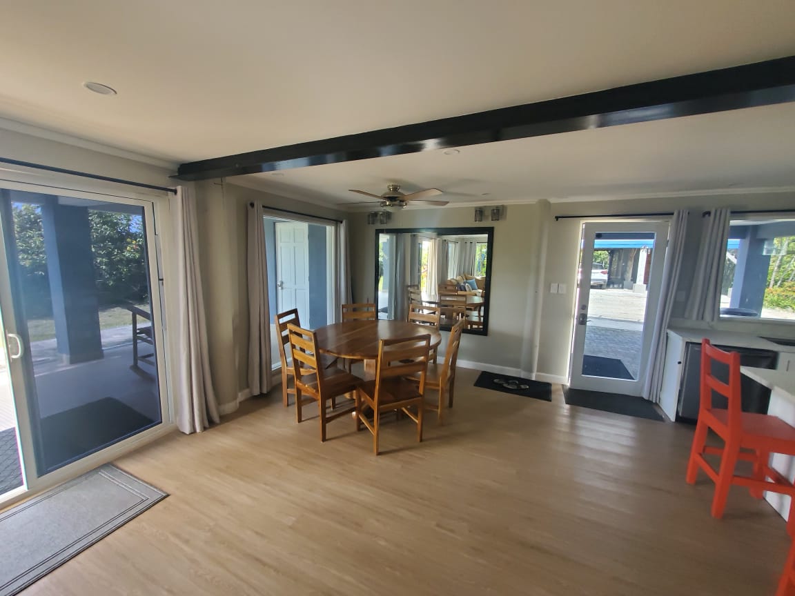 Dining room with teak table and double door porch access