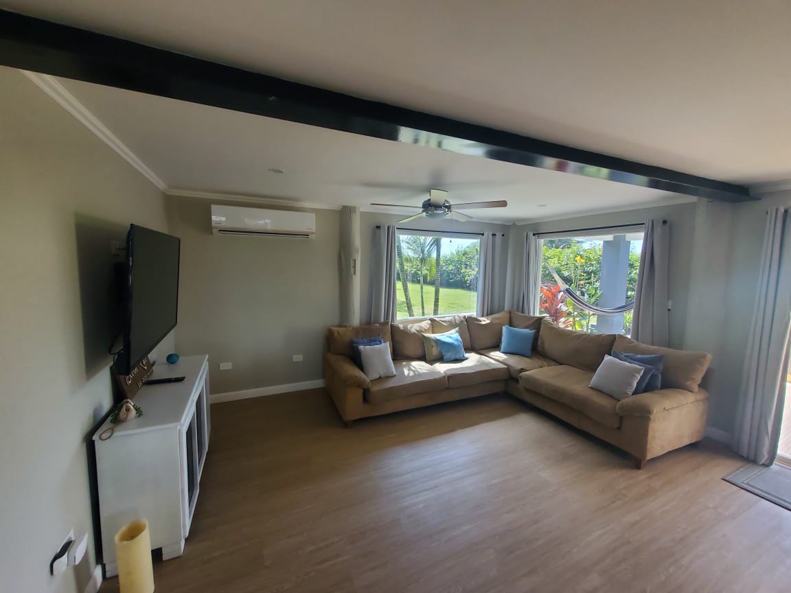 Spacious living room with large TV and sectional sofa