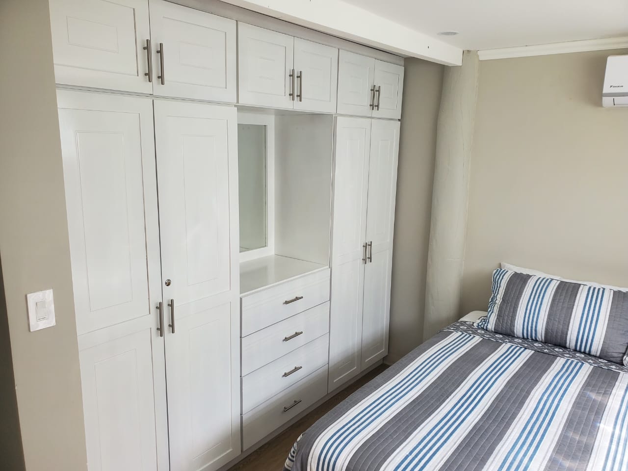 Bedroom with large built-in closet wall