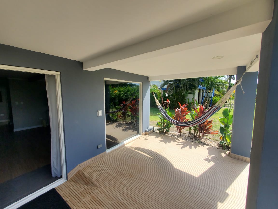 Patio deck with hammock and tropical garden