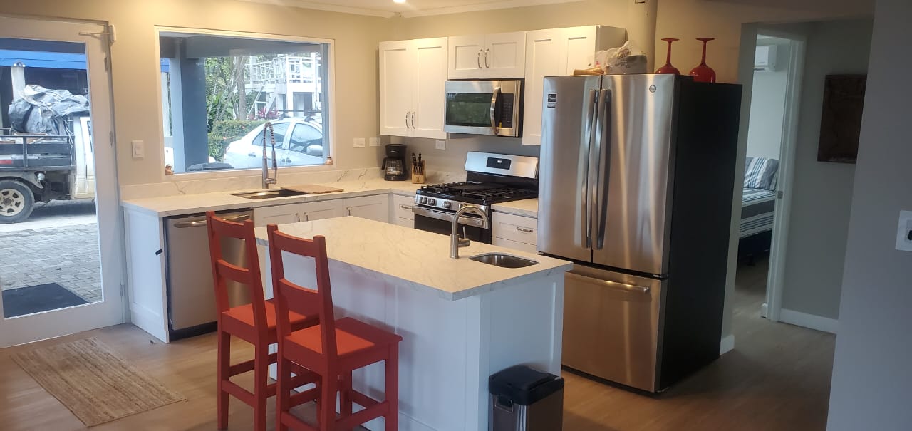 Kitchen with island and red bar stools