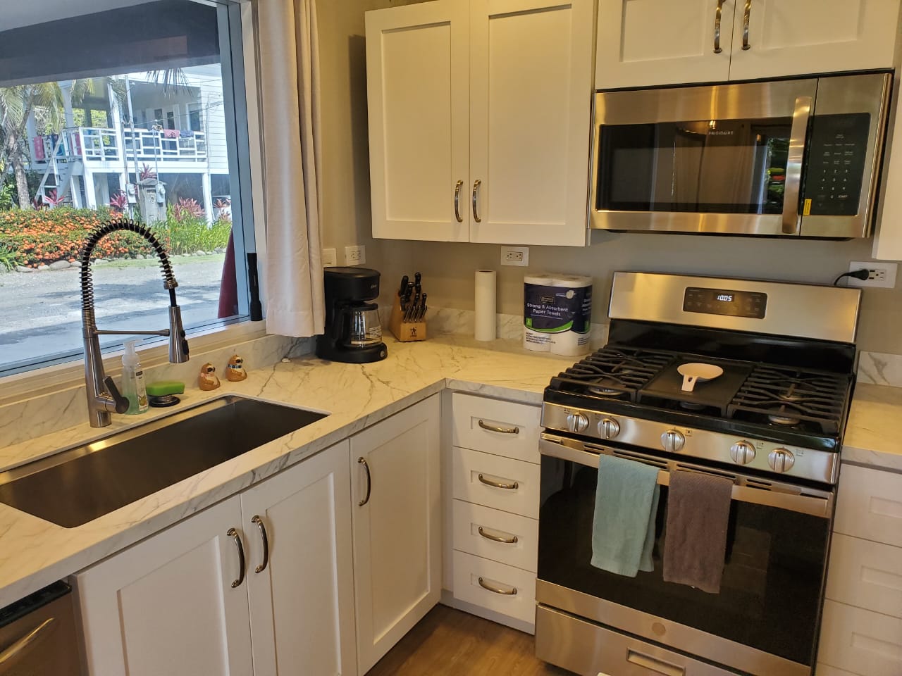 Kitchen counter with stainless stove and marble countertops