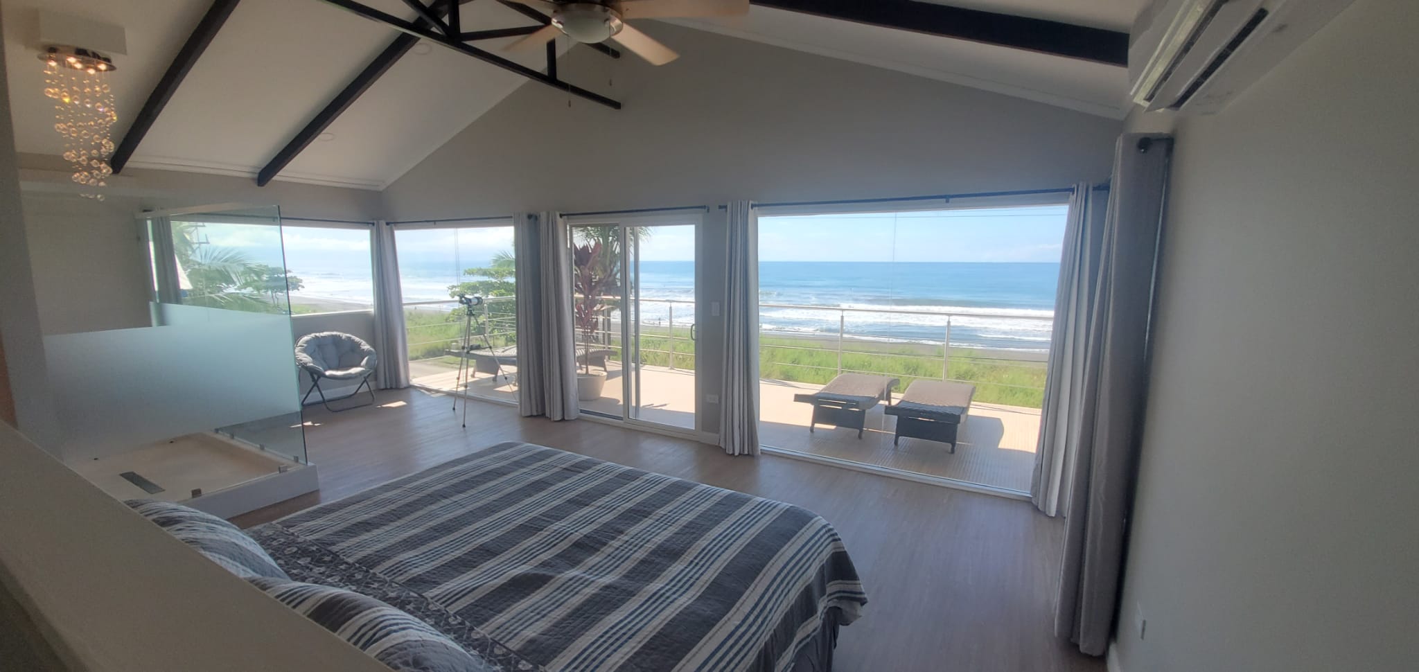 Sloth Life Beach House — master suite with ocean views and cathedral ceiling