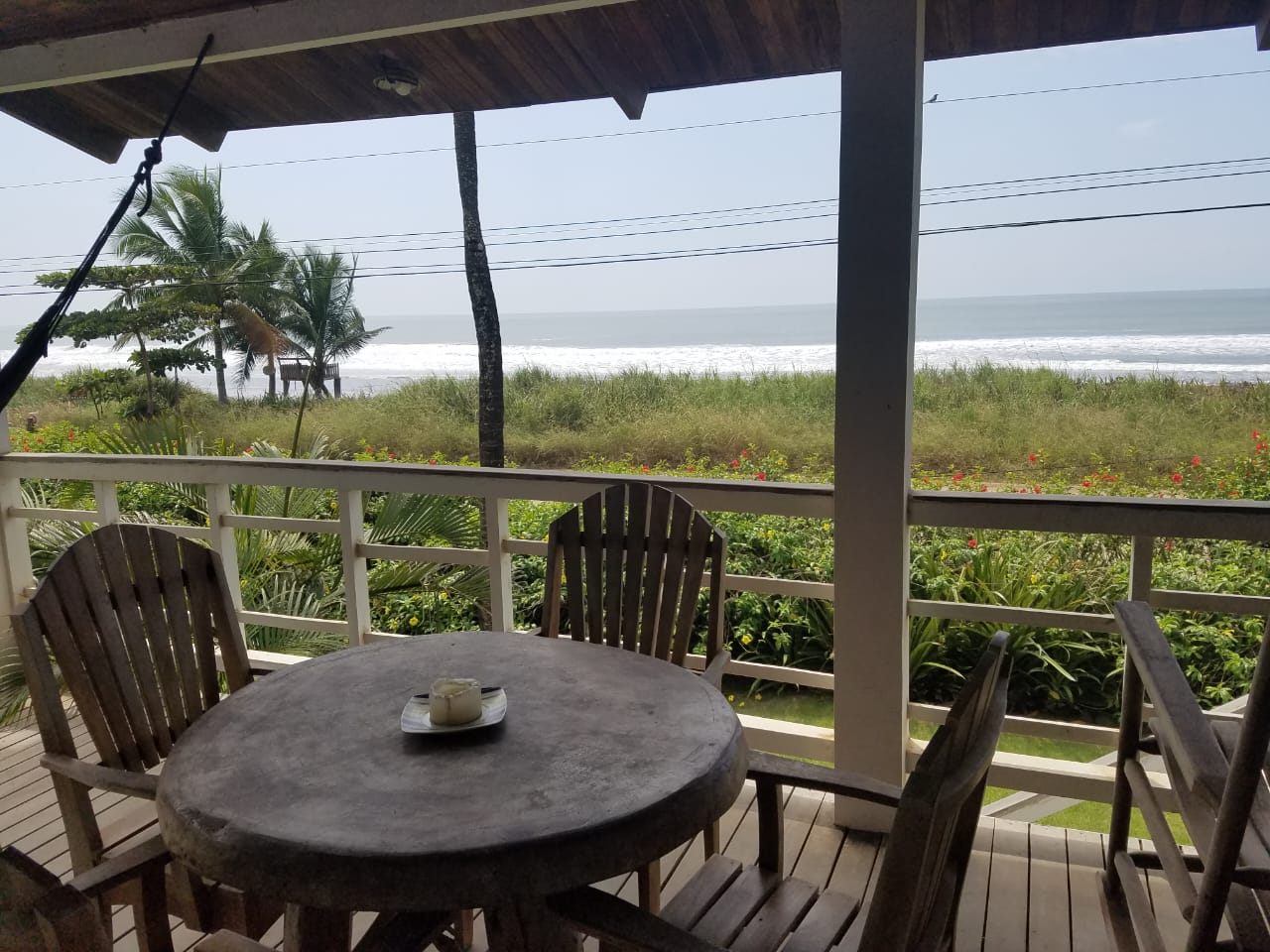 Oceanfront deck with table and chairs, panoramic Pacific views