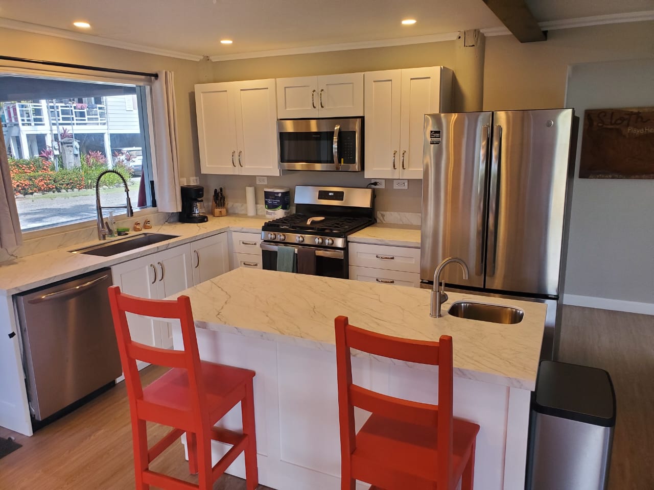 Kitchen with island and red bar stools