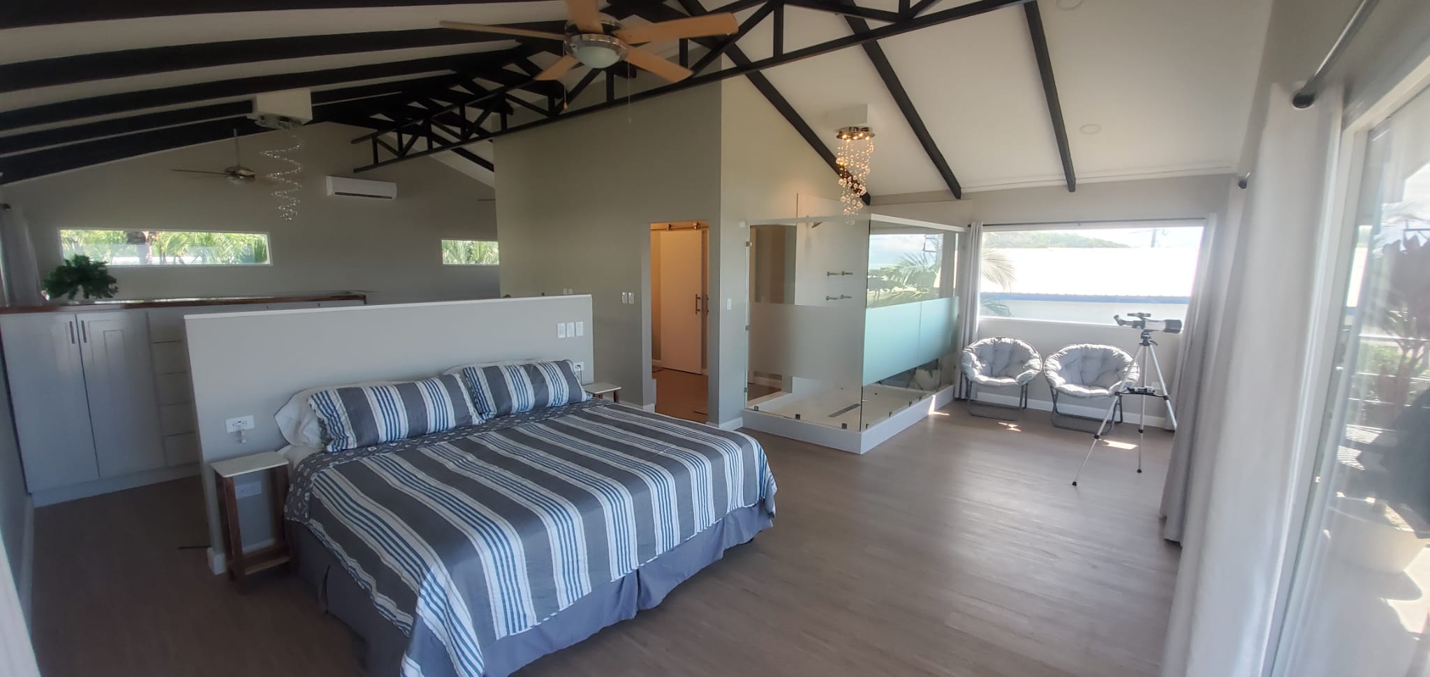 Master suite with king bed, vaulted ceiling and glass shower enclosure